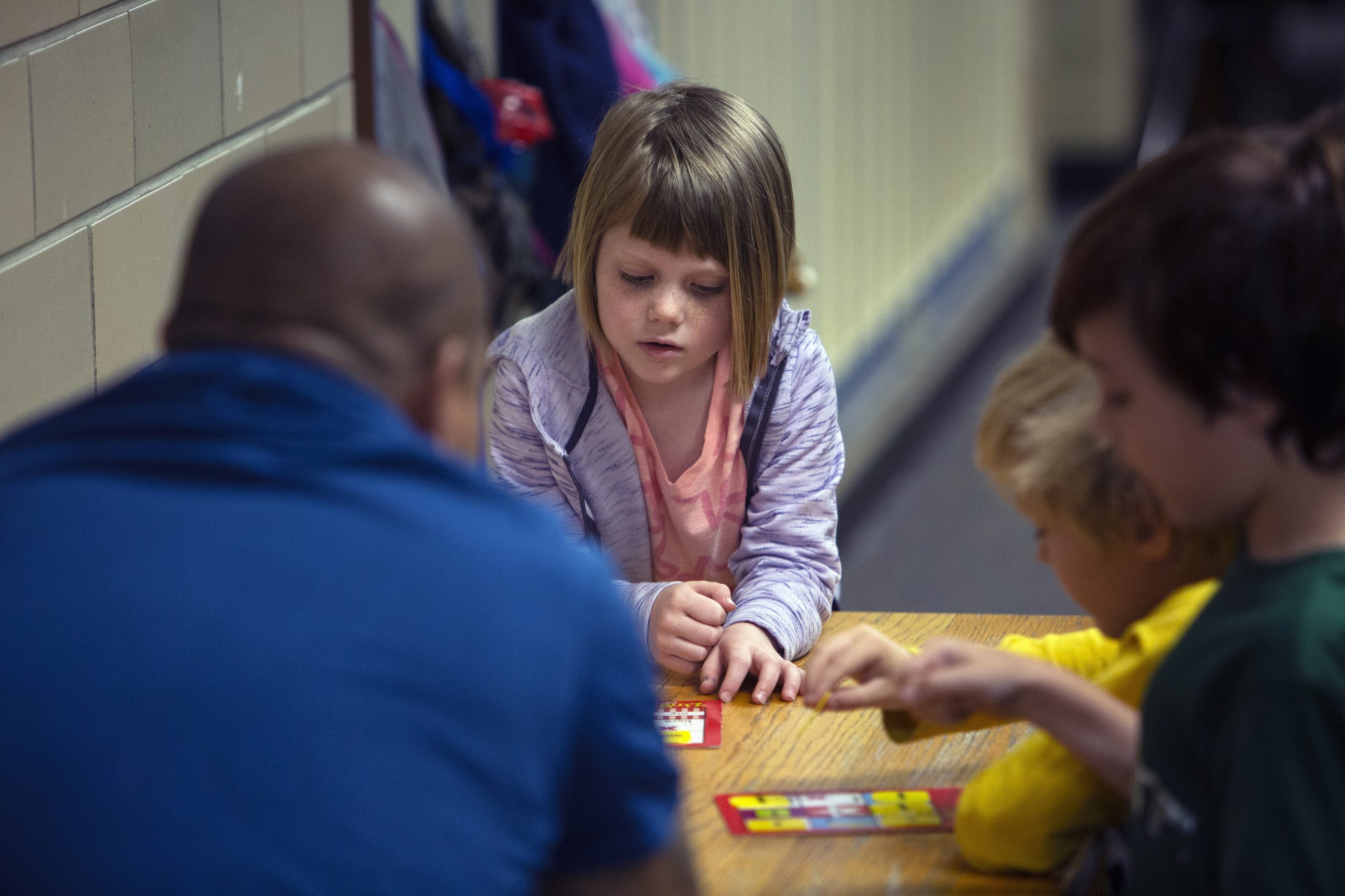 Three students working in small group with teacher